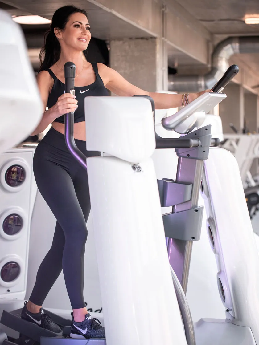 Kobieta ćwicząca na orbitreku Body Space® z kapsułą podciśnieniową i podczerwienią
